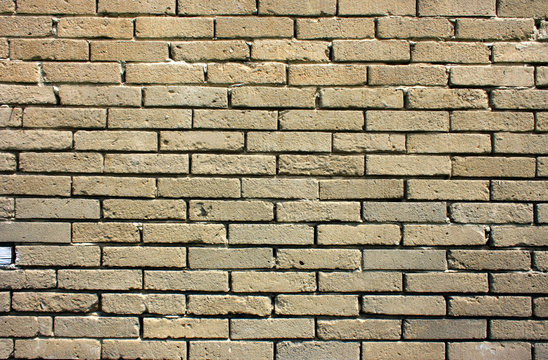 Fototapeta Stary, zniszczony mur z szarych cegieł - tło w stylu wabi-sabi
