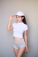 Asian girl wearing sportswear attire shots body length.