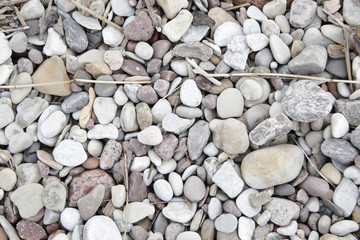 small grey white pink pebbles on the beach background