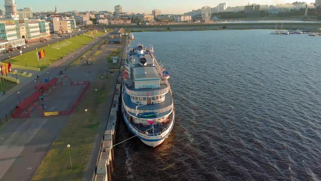 Cruise ship at the pier at sunset. Tourism. Aerial footage 