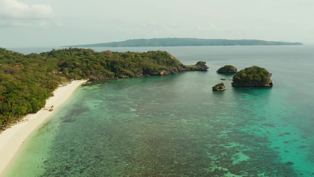 Tropical sandy beach near the blue lagoon and corall reef, aerial view Boracay, Philippines. Ilig Iligan Beach. Summer and travel vacation concept.