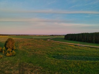 sunset over green field