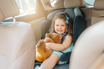 Cute little baby child sitting in car seat. Portrait of cute little baby child sitting in car...