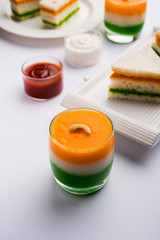 Tiranga / Tricolour sweet food made using indian flag colours and served in a glass in layers. selective focus