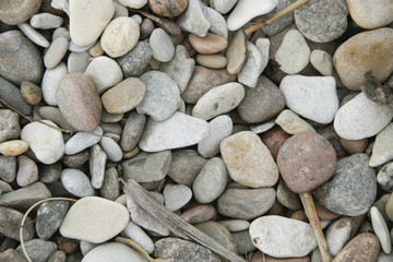 small grey white pink pebbles on the beach background