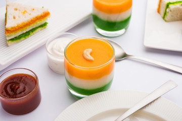 Tiranga / Tricolour sweet food made using indian flag colours and served in a glass in layers. selective focus