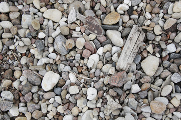 small grey white pink pebbles on the beach background