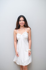 Asian girl with nice outfit, wearing sleeveless dress.