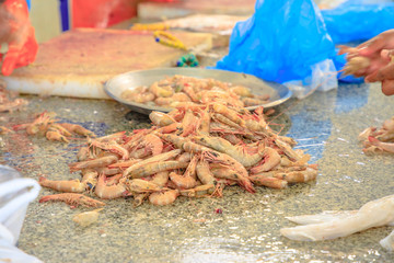 Fish cleaning. Close up of shrimps at Al Khor Fish Market located near to corniche. Qatar, Middle East, Arabian Peninsula.