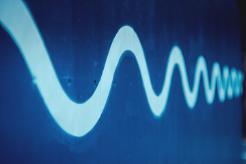 sine curve waves with depth on blue wood background