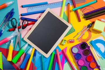 Preparation of primary school children. Bright and multicolored school background with stationery accessories for the study of general subjects. Flat Lay, Copy space, place for text.