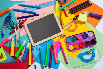 Preparation of primary school children. Bright and multicolored school background with stationery accessories for the study of general subjects. Flat Lay, Copy space, place for text.