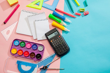 Preparation of primary school children. Bright and multicolored school background with stationery accessories for the study of general subjects. Flat Lay, Copy space, place for text.