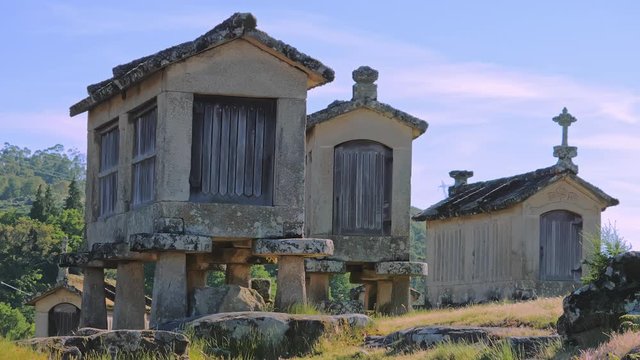 Espigueiros crowned on stone hill in Soajo settlement of Peneda-Geres