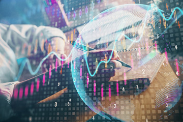 Financial forex charts displayed on woman's hand taking notes background. Concept of research. Double exposure