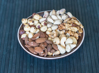 Healthy food. Nuts mix assortment on stone texture top view. Collection of different legumes for background image close up nuts, pistachios, almond, cashew nuts, peanut, walnut. image