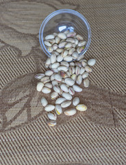 Fototapeta na wymiar Healthy food for background image close up pistachios nuts. Texture on top view Nuts pistachio on the cup plate