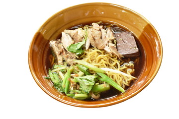 egg noodles with boiled duck in Chinese herb brown soup on bowl