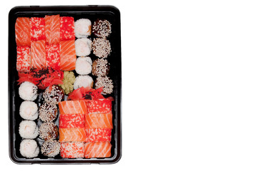 Big sushi set ib black plastic box on white background, top view close up, copy space