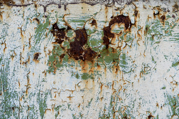 rusty corrosion on a metal base. Paint peeling off a metallic surface. Metal base rust, paint...