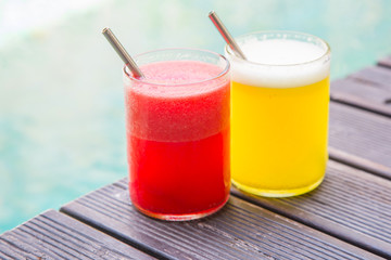 Delicious healthy summer drinks, watermelon and pineapple juice in glasses with reusable drinking straws