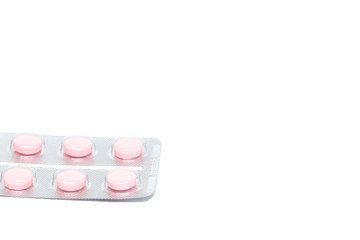 Pink tablet pills in blister , isolated on white background