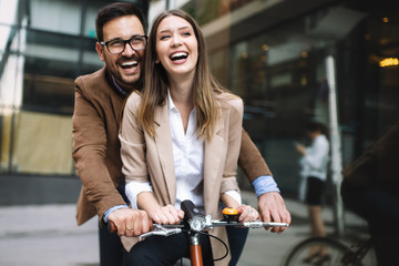 Attractive young business couple embracing at street