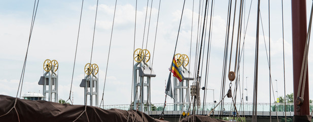 bridge called Stadsbrug in Kampen, across river IJssel. View through ropes of a ship