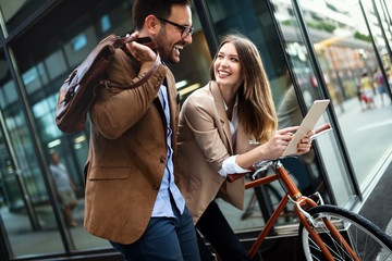 Office woman with business man couple enjoying break while talking flirting outdoor