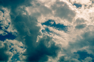 White compact clouds with small cuts of the blue sky; Against the background of clouds of bright shades and also dark closer to cloudy are strongly noticeable.