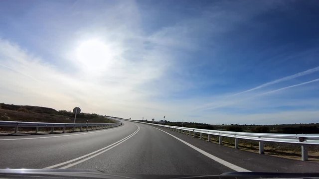 4K, POV view of car driving on highway in the provinces of Seville, southern Spain. A car drives on a freeway. Asphalt with white line at new road.-Dan