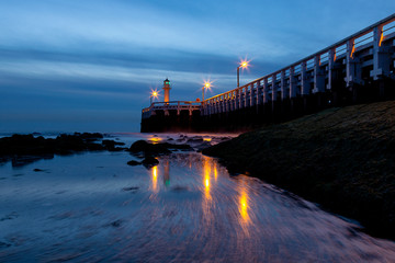 Fototapeta na wymiar The blue hour at the pier of Nieuwpoort on the Belgian coast, Belgium