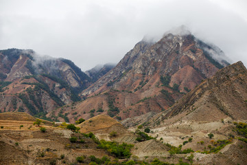 Photo of mountain slopes, smog, cloudy sky