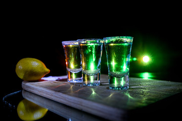 Club drink concept. Tasty alcohol drink cocktail tequila with lime and salt on vibrant dark...
