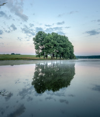 Colorful sunrise on a small lake near the village