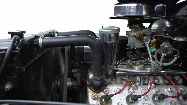 4K, Black vintage car engine under hood of a classic American Ford Mercury Eight. See the radiator cooling panel Engine and electronic system for mechanic-Dan
