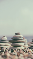 Balance pyramid from sea stones on blurred background. Calm and rest place on the beach. Zen garden. 