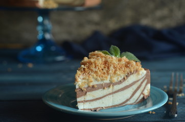 A piece of cheesecake cold on a plate on a wooden background