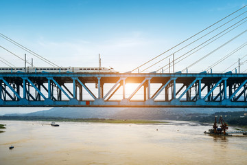 The high-speed train runs at high speed on the railway bridge. The Yangtze River Bridge of Chongqing Railway, China