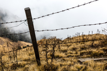 Barbed wire on the edge of a cliff. Concept of limiting individual freedom