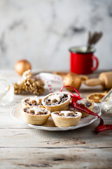 Homemade festive mince pies on white plate © marysckin