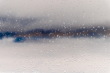 Rain window and stormy sky behind it. Abstraction