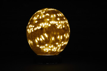 Souvenir from natural carved ostrich eggs backlit in the dark