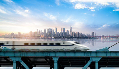 High-speed rail speeds on Bridges and the modern city skyline of chongqing, China