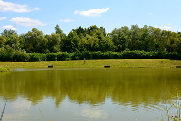 Lake in Transylvania. Typical rural landscape in the plains, Romania. Green landscape in the midsummer, in a sunny day