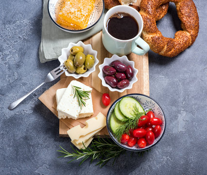 Traditional turkish breakfast with olives, simit bagels, feta cheese, cup of coffee, square image