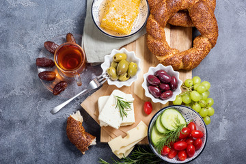 Traditional turkish breakfast with olives, simit bagels, feta cheese, tea with dates