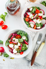 Salad with cherry tomatoes, radsh and mozzarella, lettuce mix