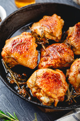 Delicious fried chicken thighs in a cast iron skillet