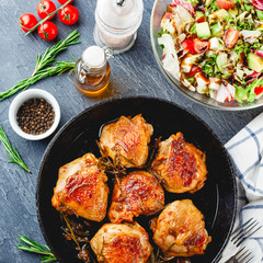 Delicious fried chicken thighs in a cast iron skillet